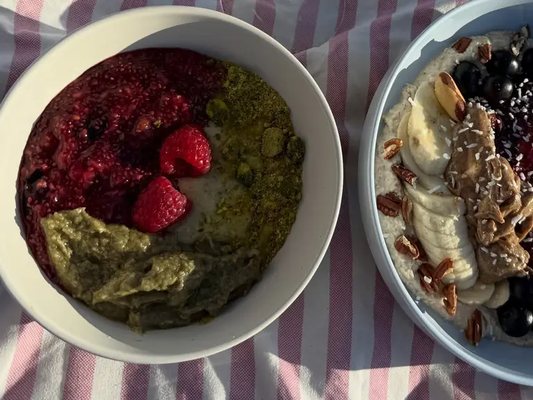 Two Sante Organics bowls seen from above on a striped towel: the Pistachio Addiction Bowl and the first signature bowl